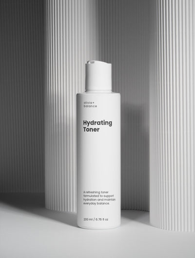 olivia+ hydrating toner bottle on a gray background