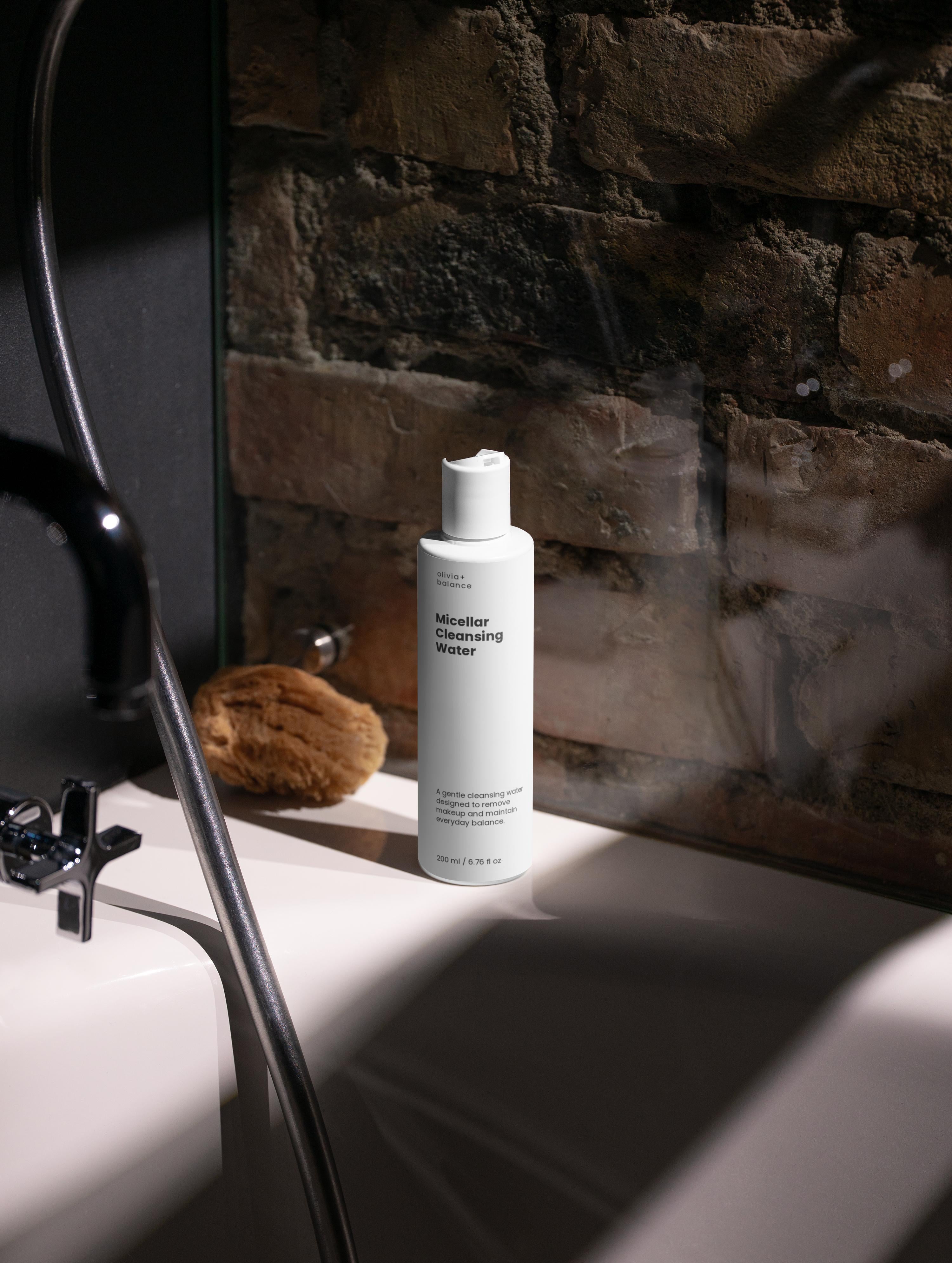 White bottle of Verai Skin product on a bathroom counter with a brick wall background