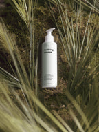 Rivelle bottle among grass and moss