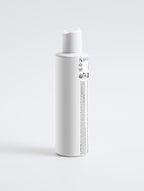 White bottle with a label on a light gray background