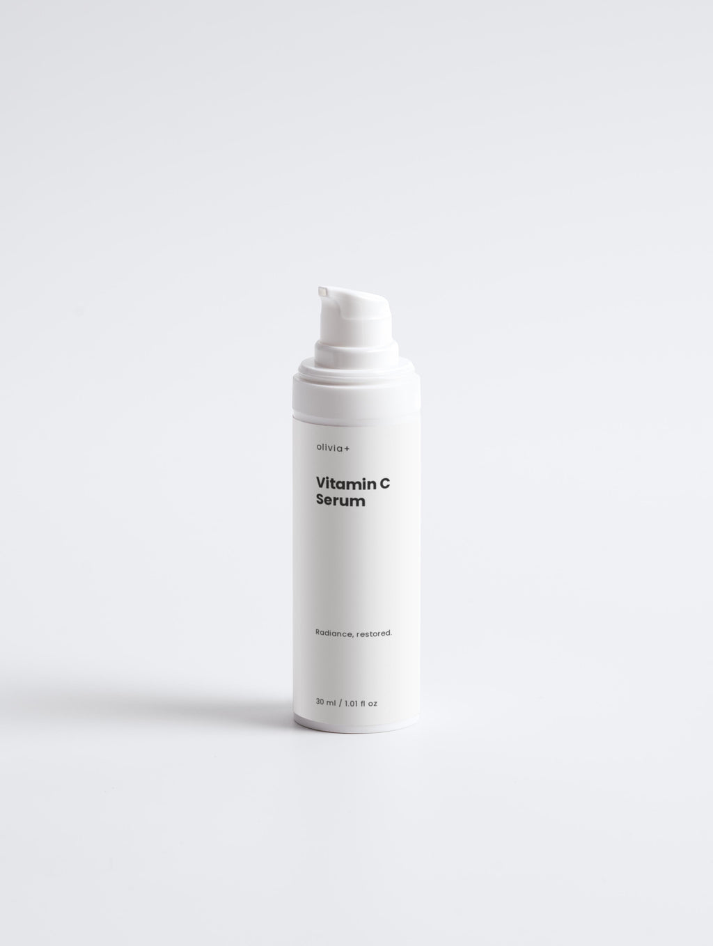 White bottle of Vitamin C Serum on a light gray background