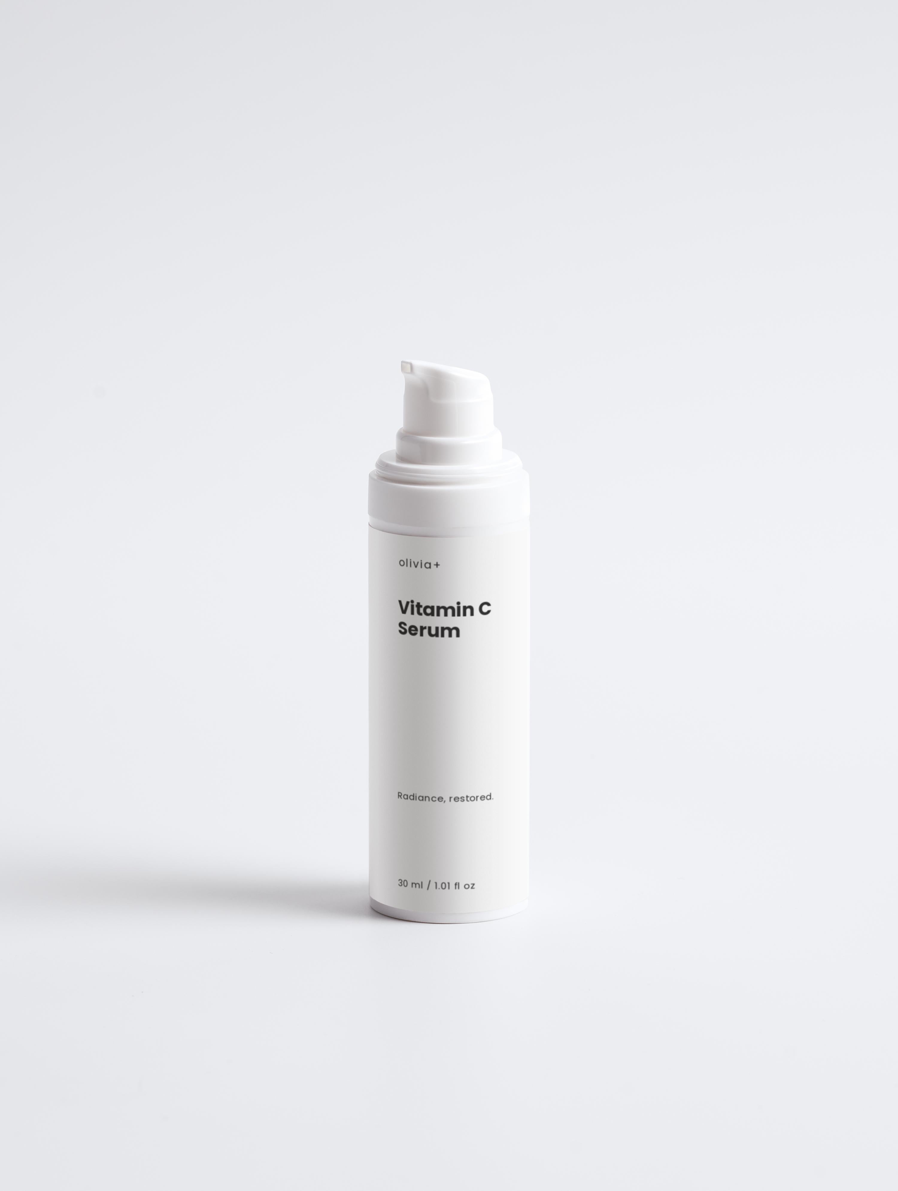 White bottle of Vitamin C Serum on a light gray background