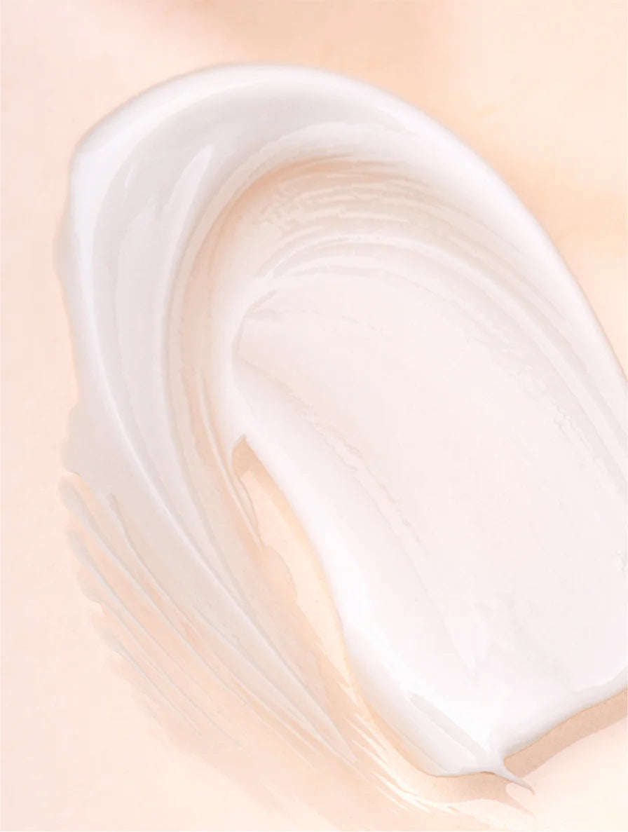 White cream or paint swatch on a beige background
