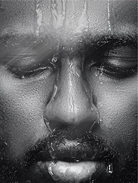 Close-up of a person's face with water droplets on a rainy day.