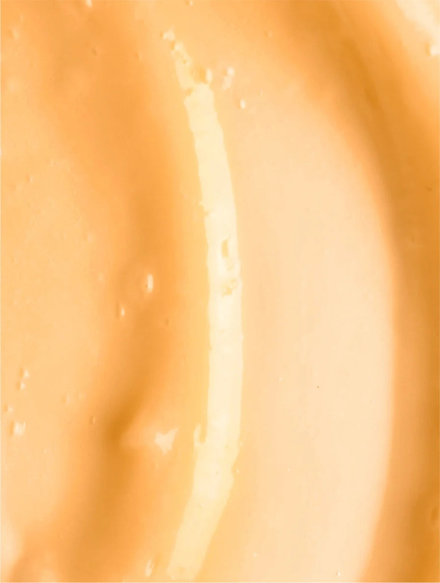 Close-up of a smooth, light orange cream or paint texture