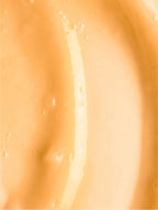 Close-up of a smooth, light orange cream or paint texture