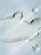 Silver liquid droplet on a light blue background