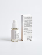 Skincare serum bottle with packaging on a white background