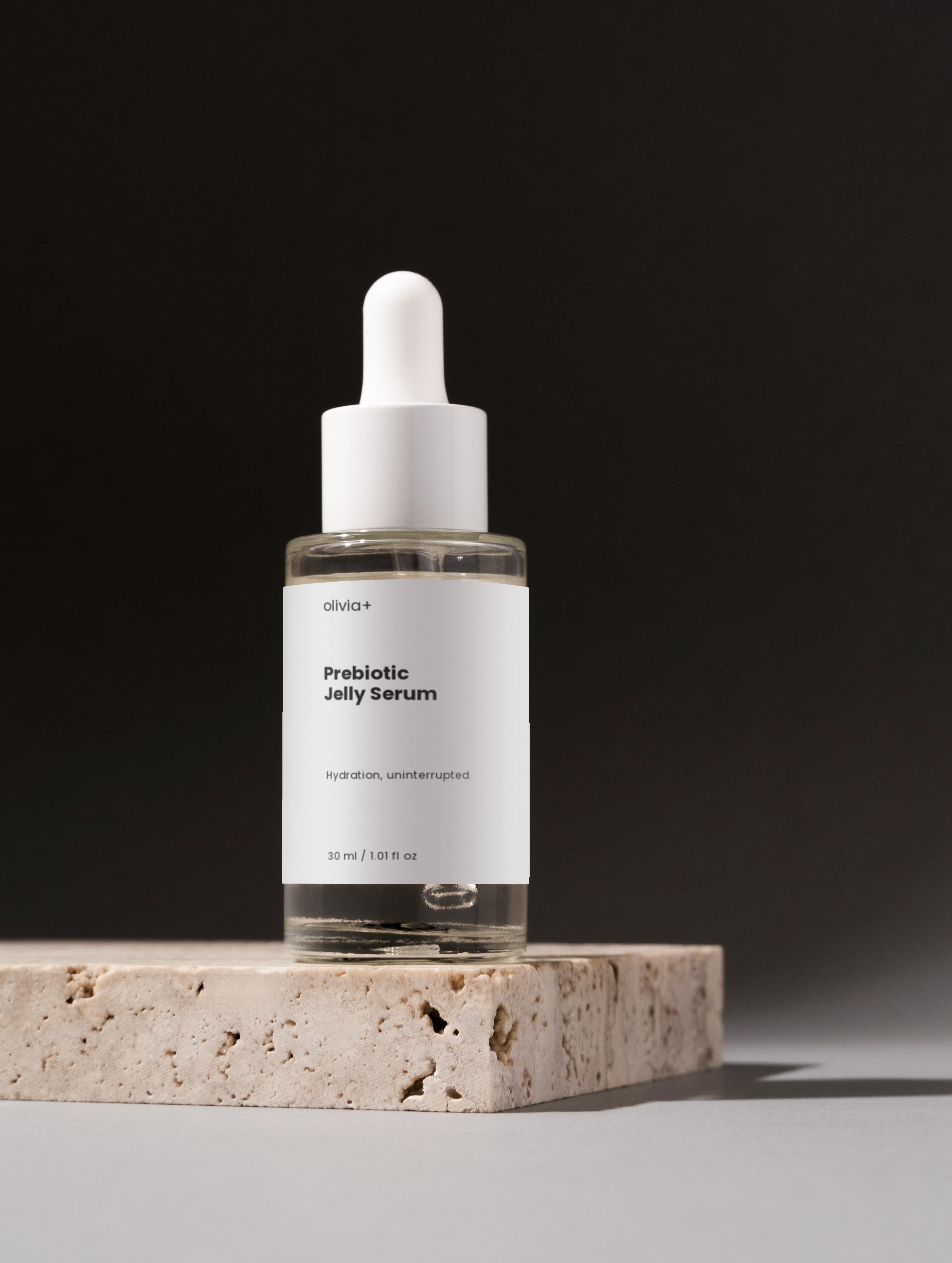 Bioactive Prebiotics Jelly Serum bottle on a stone surface with a dark background