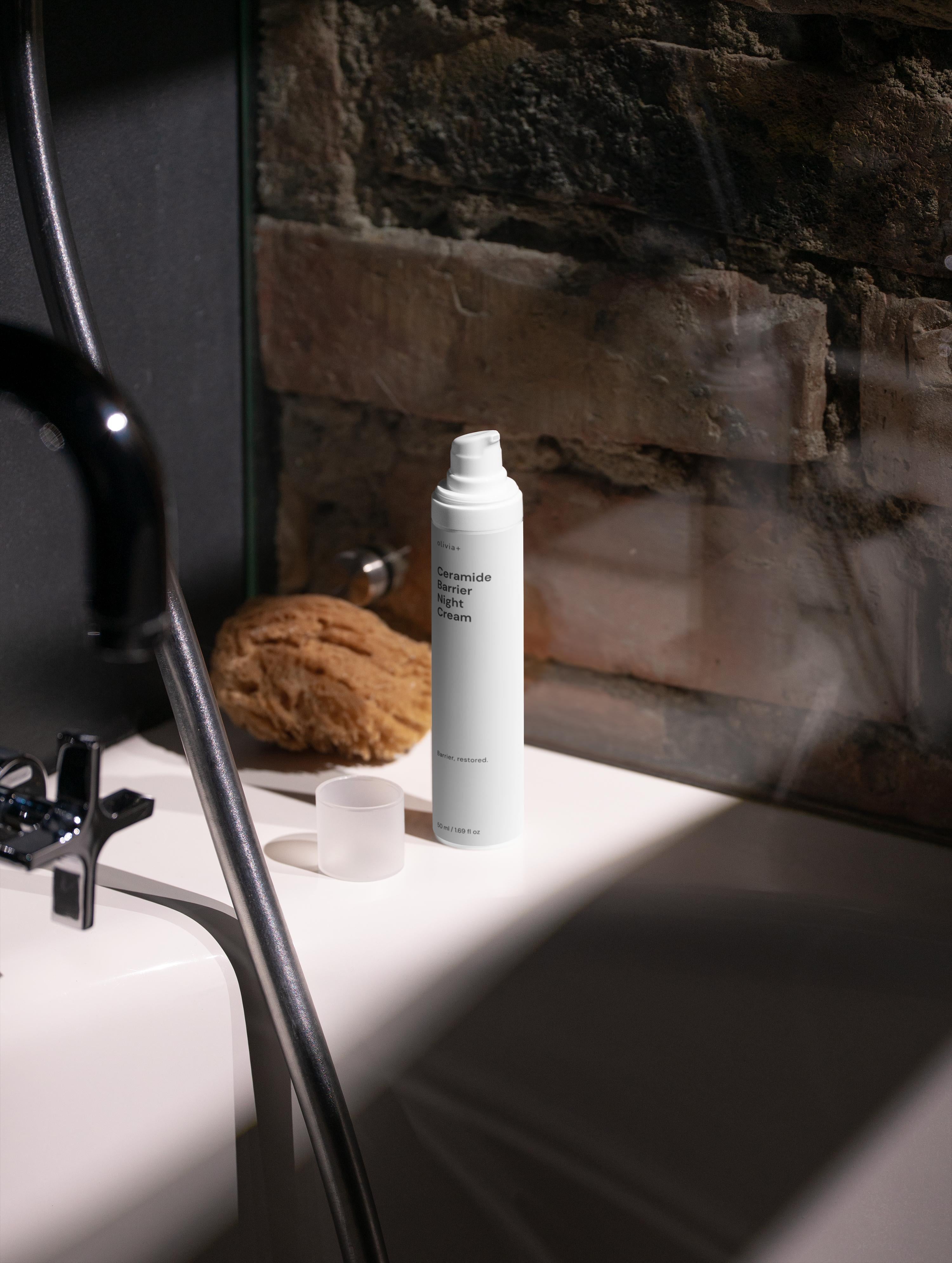 Skincare product on a bathroom counter with a stone wall background