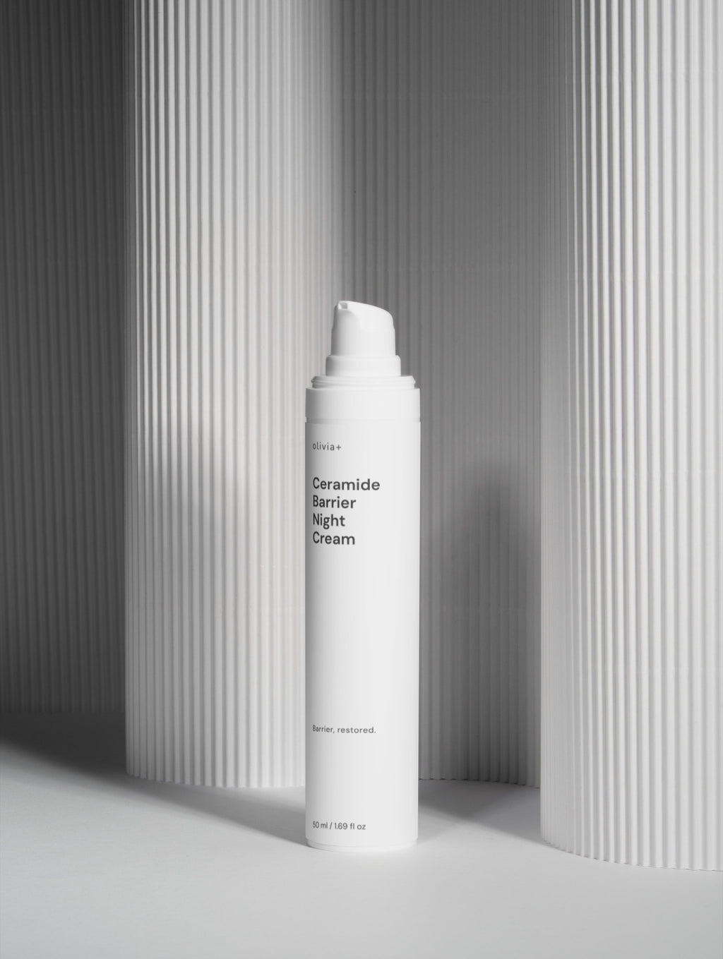 White cream bottle labeled 'Ceramide Barrier Night cream' on a gray background
