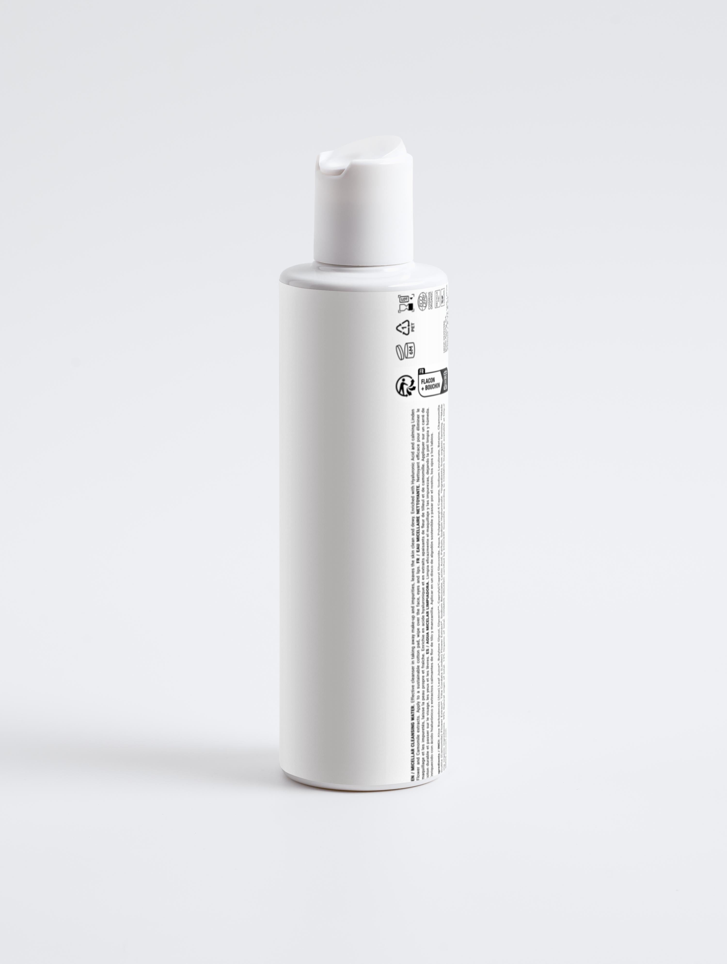 White bottle with a label on a light gray background