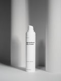 White bottle of 'The Daily Veil' on a gray background