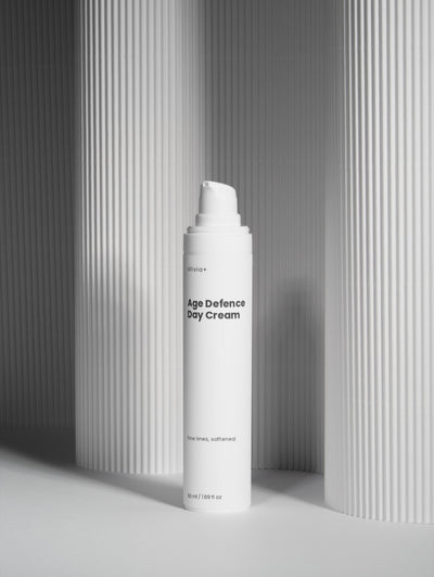 White bottle of 'The Daily Veil' on a gray background